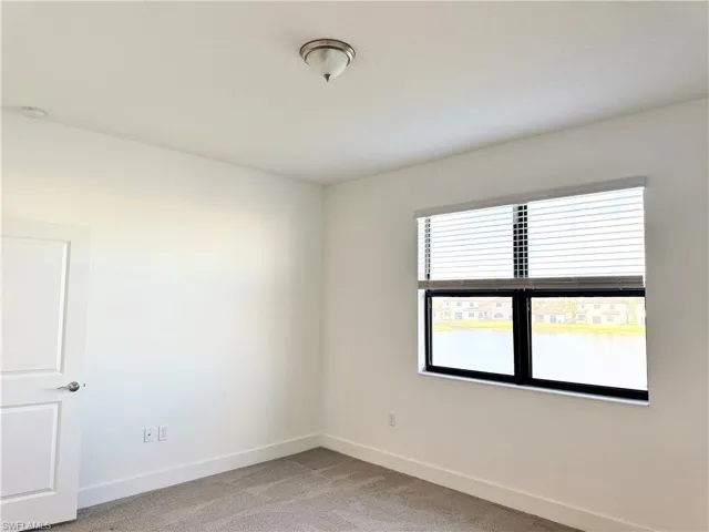 Empty room featuring carpet flooring