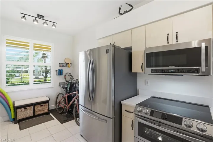 Stainless steel appliances and tile floors.