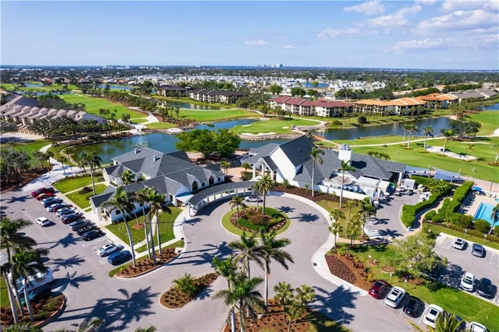 Expansive property featuring golf course fairways, multiple water features, and a large central building with a covered drive