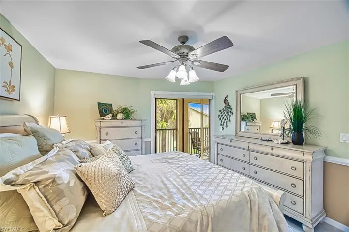 Ceiling fan with integrated lighting, soft green wall color, crown molding, and direct access to an outdoor area