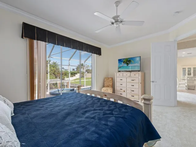 Bedroom featuring access to exterior, ceiling fan, and crown molding