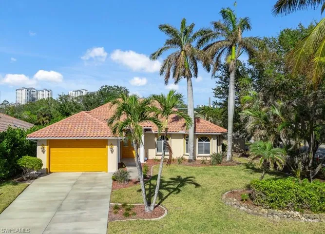 Mediterranean / spanish house with a garage and a front yard