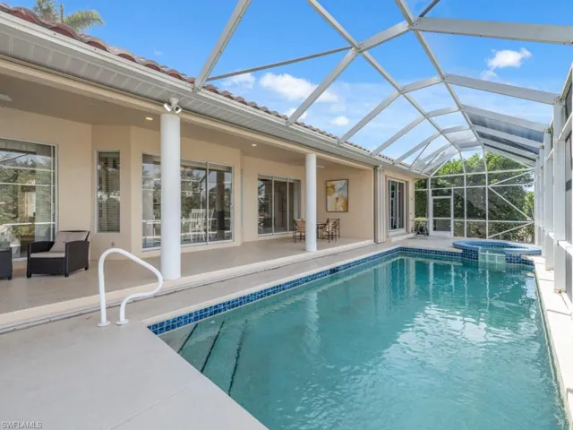 View of pool featuring a patio area, a lanai, and an in ground hot tub
