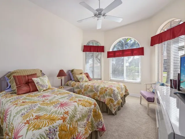 Carpeted bedroom with ceiling fan