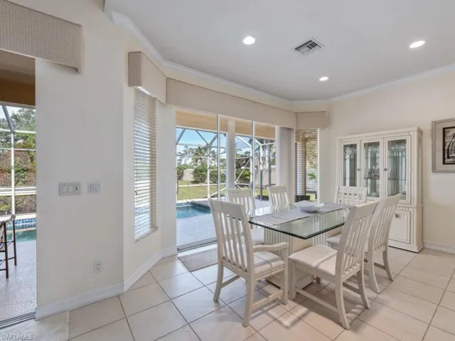 Dining space featuring ornamental molding, light tile patterned floors, and a healthy amount of sunlight