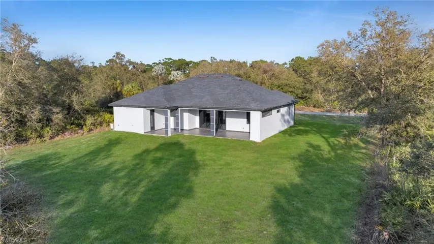 Back of property with a yard