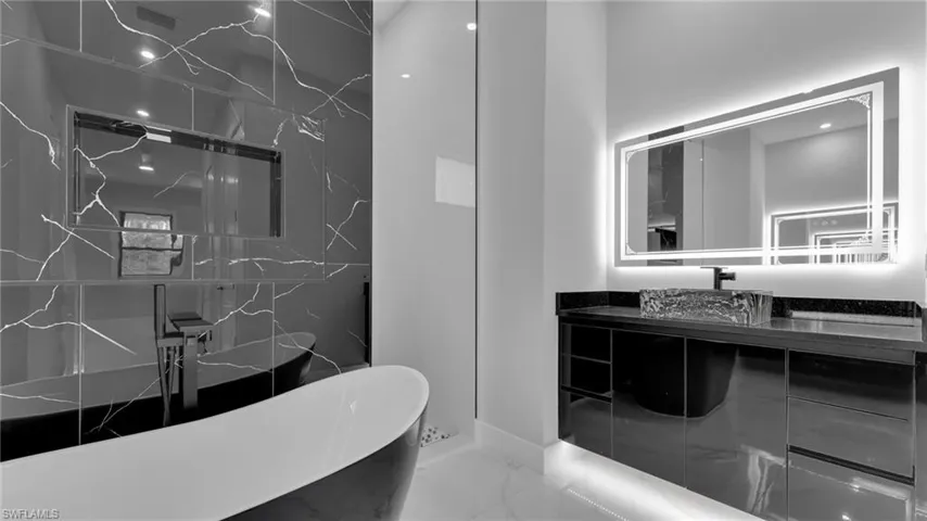 Bathroom with a tub and vanity