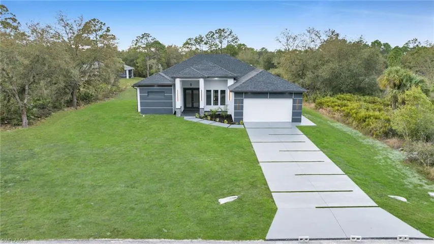 View of front facade with a front yard and a garage