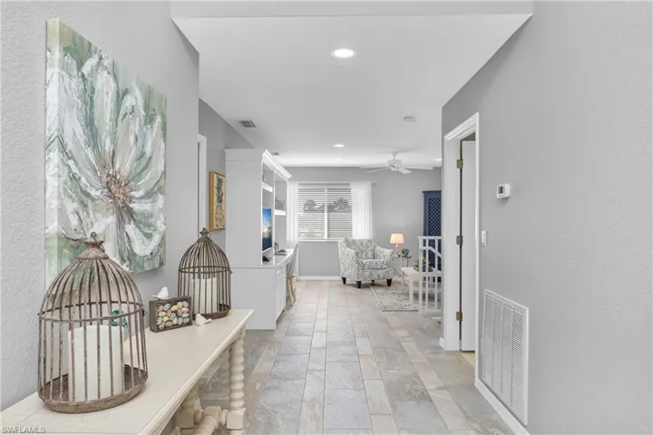 Hallway with recessed lighting and visible vents