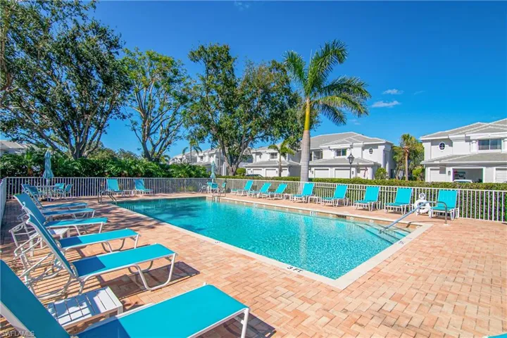 Pool with a patio area and fence