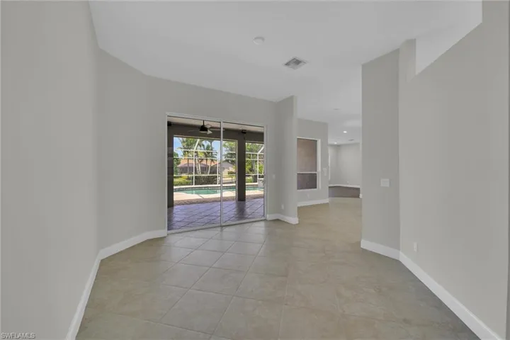 Unfurnished room featuring light tile patterned floors, baseboards, and a ceiling fan