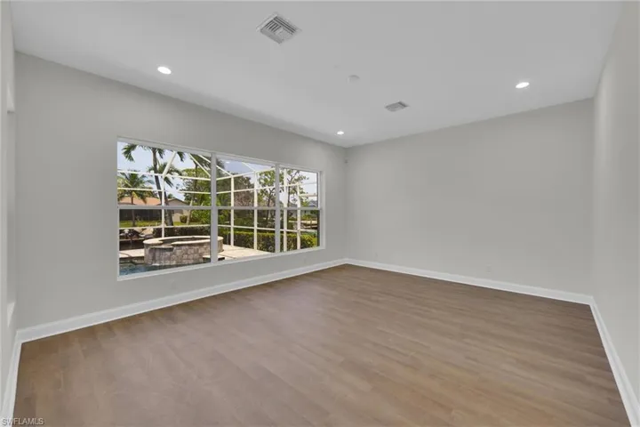 Spare room with visible vents, wood finished floors, baseboards, and recessed lighting
