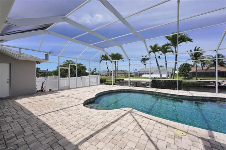 Outdoor pool featuring a patio area, a lanai, and a residential view