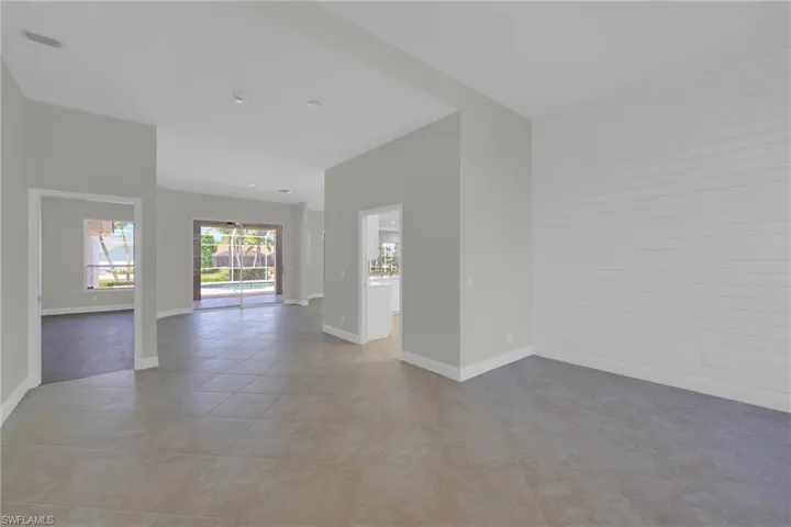 Spare room with light tile patterned floors and baseboards