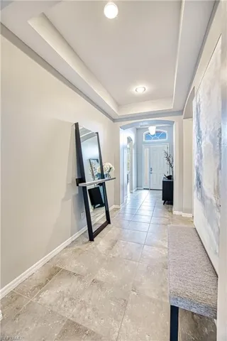 Hallway featuring a tray ceiling