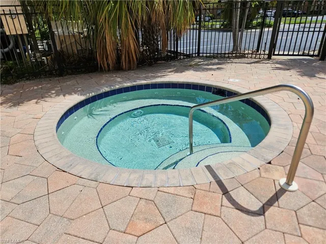 View of pool featuring a community hot tub and a patio area