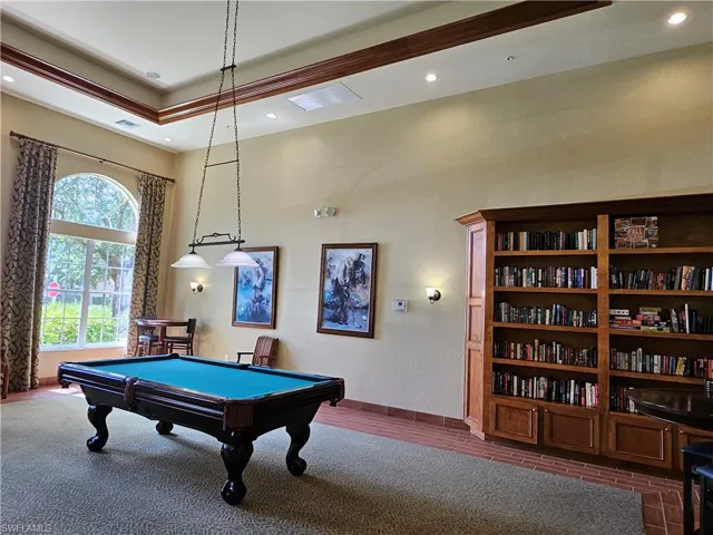 Rec room with pool table and dark colored carpet