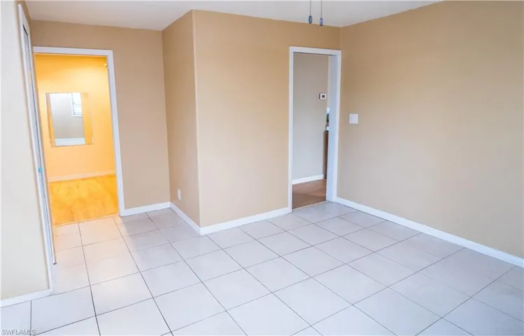 Unfurnished room featuring light tile patterned flooring