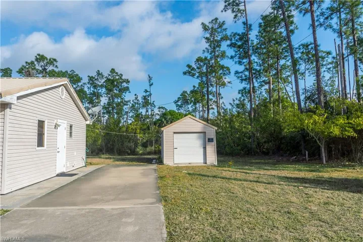View of grassy yard with a shed