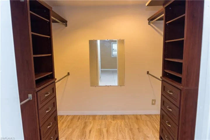 Spacious closet with light wood-style flooring