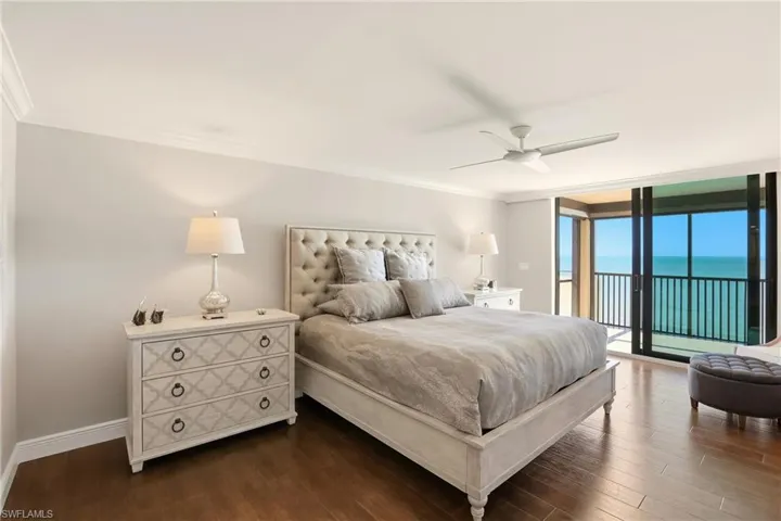 Bedroom featuring floor to ceiling windows, crown molding, a ceiling fan, access to exterior, and wood finished floors