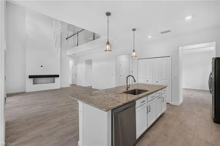Kitchen island with a built-in sink and stainless steel dishwasher
