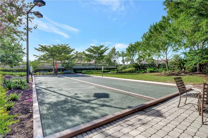 Surrounding community with a bocce ball area and a lawn