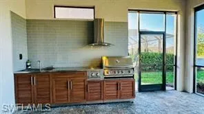 View of patio featuring area for grilling