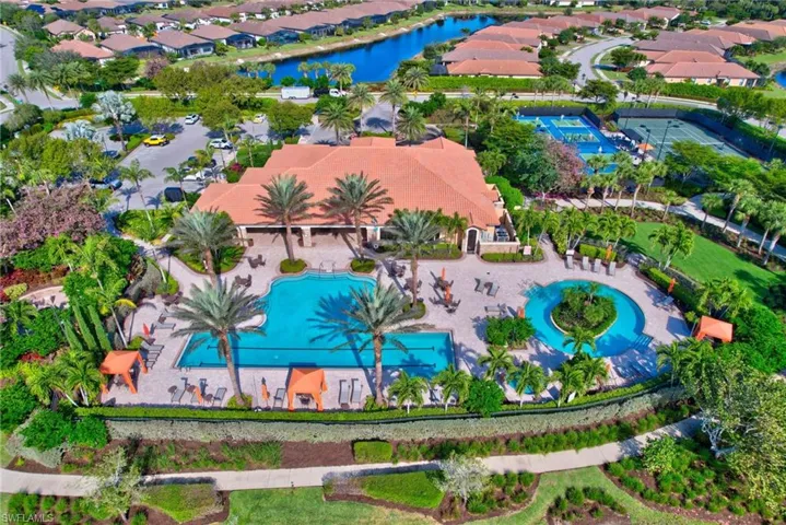 Aerial view of residential area featuring a large body of water and a pool area