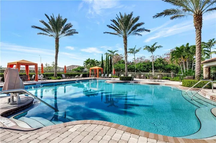 Community pool with a patio area and a gazebo