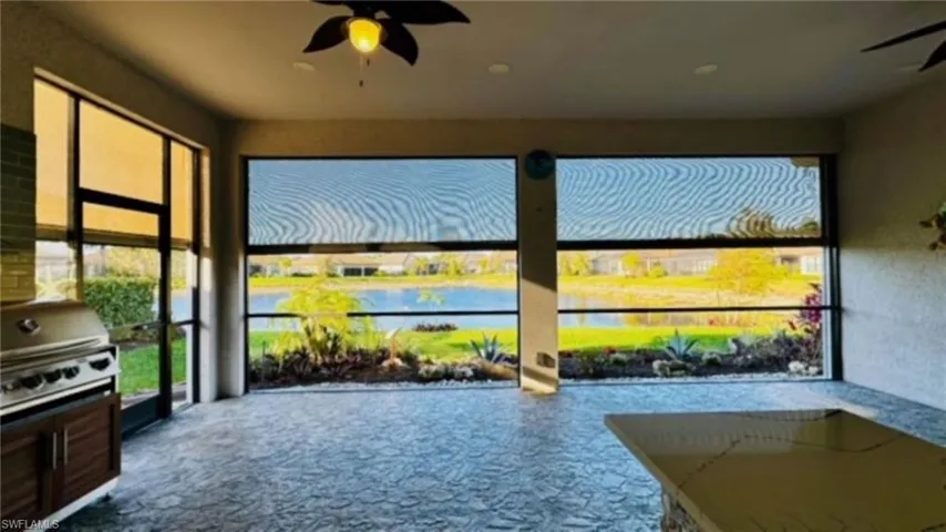 Sunroom featuring a water view