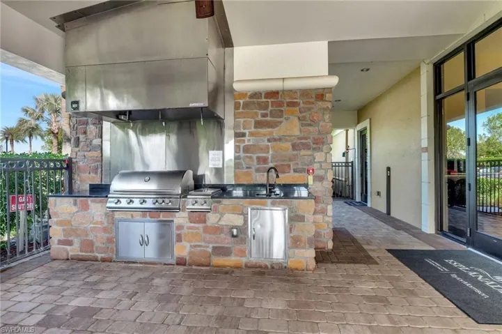 View of patio featuring an outdoor kitchen and a sink