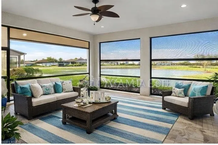 Sunroom featuring a water view, recessed lighting, and wood finished floors