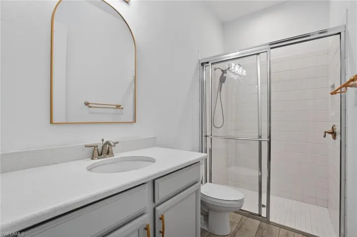 Bathroom featuring vanity and a stall shower