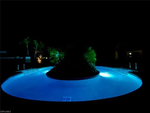 Pool at twilight featuring an outdoor pool