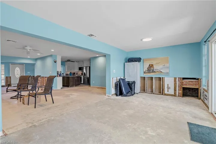 Living room with ceiling fan and a fireplace