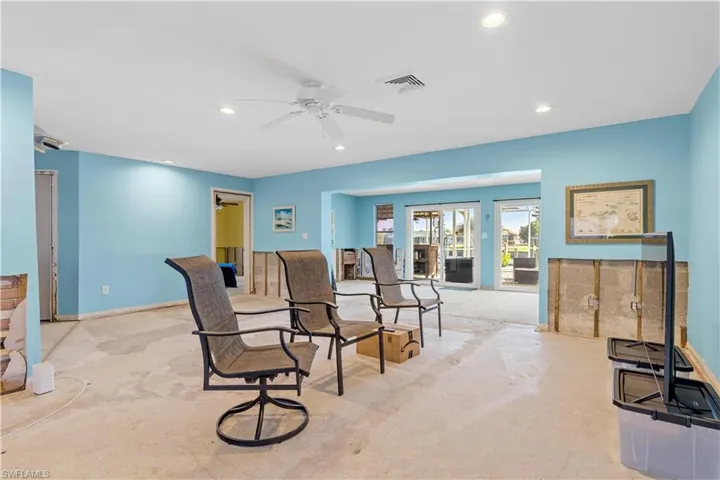 Living room with light colored carpet and ceiling fan