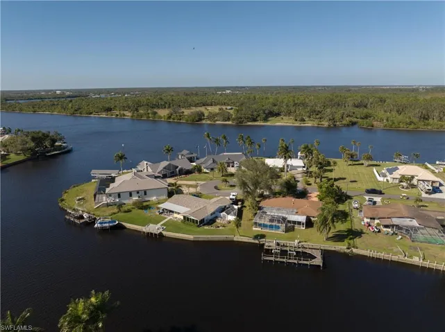 Birds eye view of property with a water view