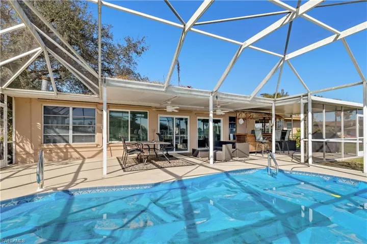 View of pool featuring a patio, ceiling fan, and a lanai