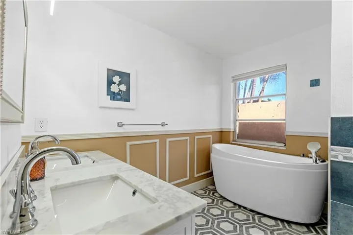 Bathroom featuring a bathing tub and vanity