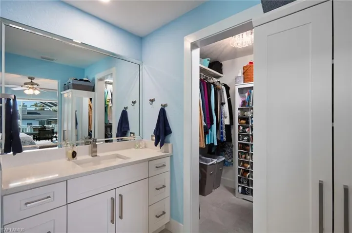 Bathroom featuring new vanity, and walk-in closet
