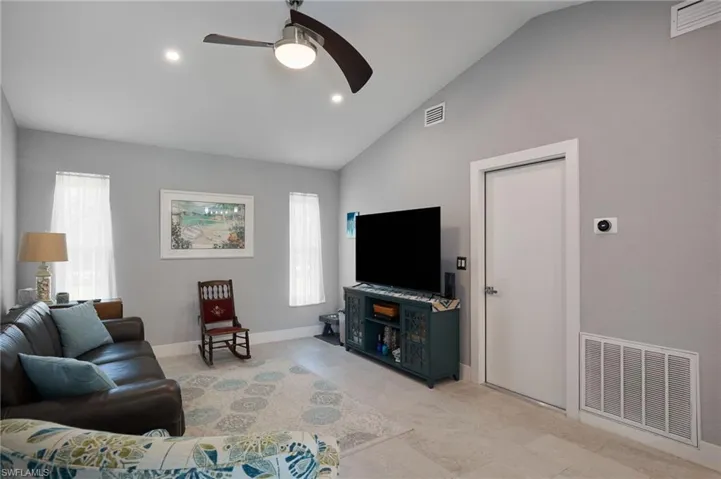 Den with vaulted ceiling; entrance to 2-car garage