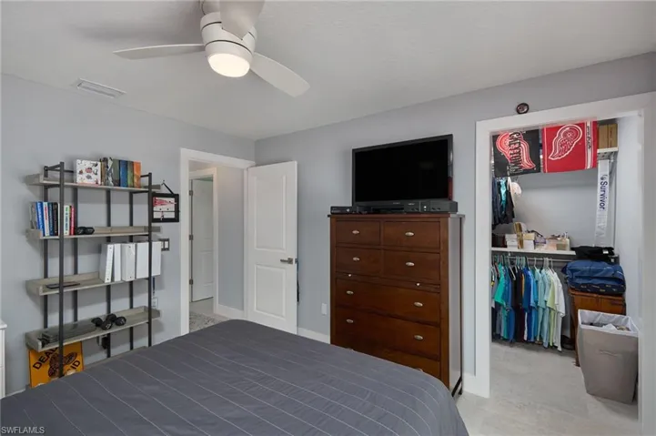Bedroom #2 with ceiling fan and a fabulous walk-in closet