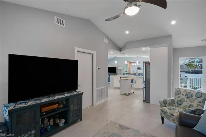 Den area with access outside to the upper deck; door to the garage