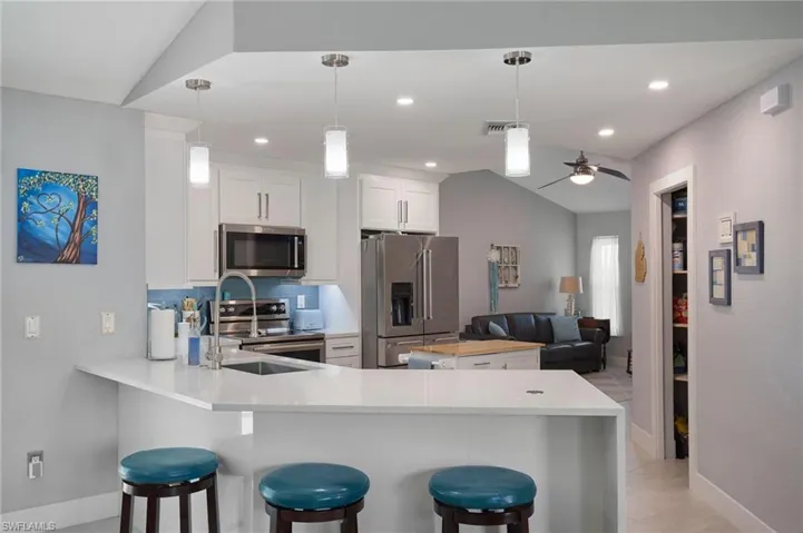 Kitchen with bar, movable island looking into the den/flexroom