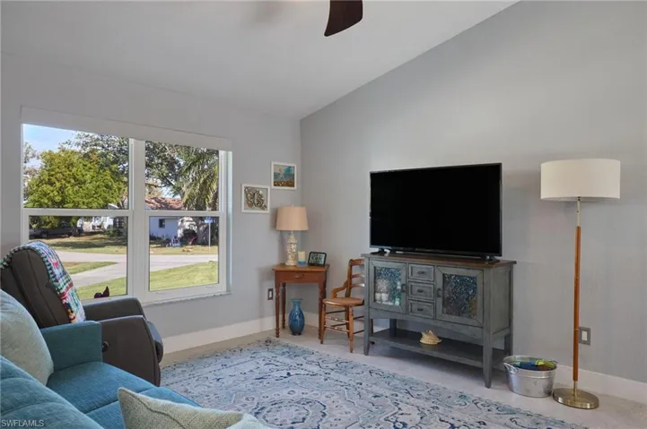 Living area next to kitchen with high ceilings