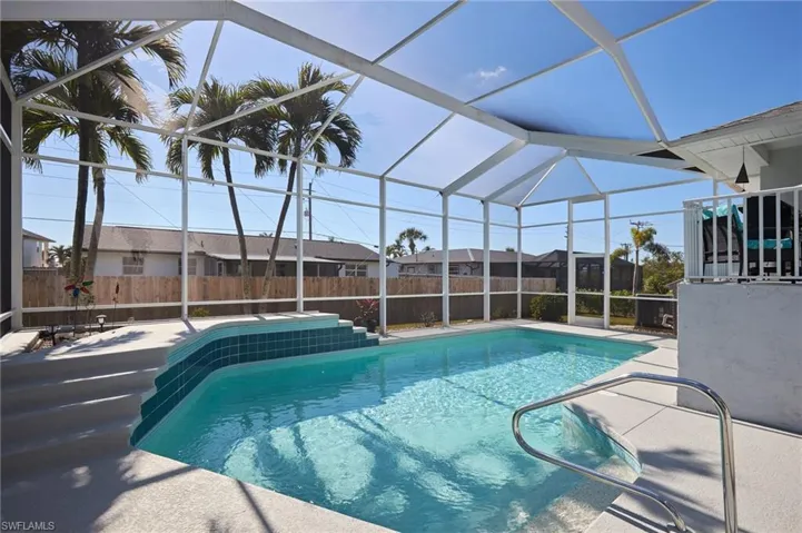 View of swimming pool with upper deck and lanai.