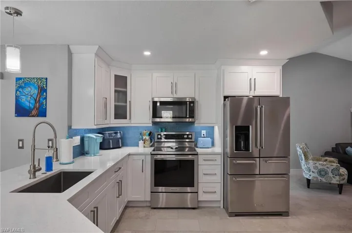 Kitchen featuring tile backsplash, new KitchenAid appliances, undermount oversized sink.