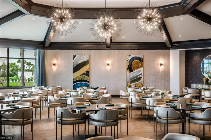 Dining space featuring beamed ceiling, a notable chandelier, and wallpapered walls