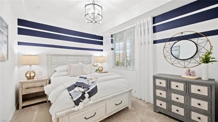 Carpeted bedroom with a chandelier